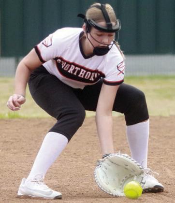 Aubryn Janda scoops up a grounder at first base to record an unassisted out against Rice Consolidated. Sticker Photo By Darrell Vyvjala