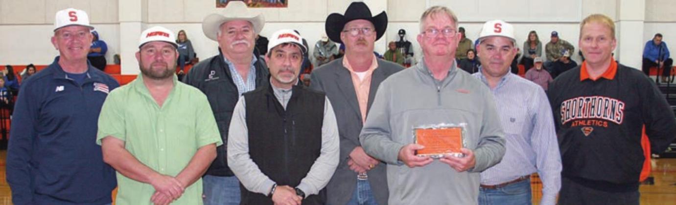 FROM THE FEB. 20 ISSUE – Richard Hoogendoorn (front, right) was presented a plaque recognizing his 400th win as Shorthorn head basketball coach by members of the Schulenburg ISD Board of Trustees and Superintendent Duane Limbaugh. Sticker File Photo