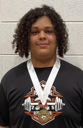 Calvin Thompson shows off the gold medal he earned at last Friday’s regional powerlifting meet.