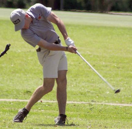 Reid Janda hits his second shot on the par-5 No. 15 hole. Sticker Photo By Darrell Vyvjala