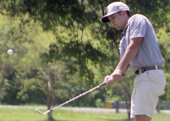 Jackson Faith chips onto the 16th green. Sticker Photo By Darrell Vyvjala