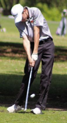 Van Prihoda strikes his approach shot on the 16th fairway. Sticker Photo By Darrell Vyvjala