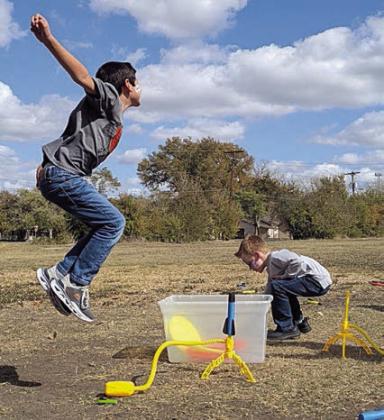 Students experiment with the principal of air pressure using stomp rockets.