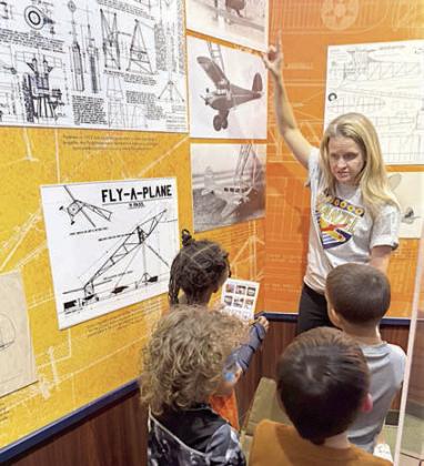 During a visual scavenger hunt, Stanzel Family Foundation CEO Cheryl Pekar assists students.