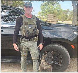 Sgt. Randy Thumann and his canine partner, Kolt, are shown with the packages of cocaine they discovered following a traffic stop on I-10 Sunday.