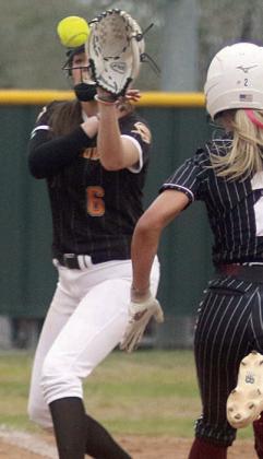 before Brenley Bujnoch receives her throw for an out at first base. Sticker Photos By Darrell Vyvjala