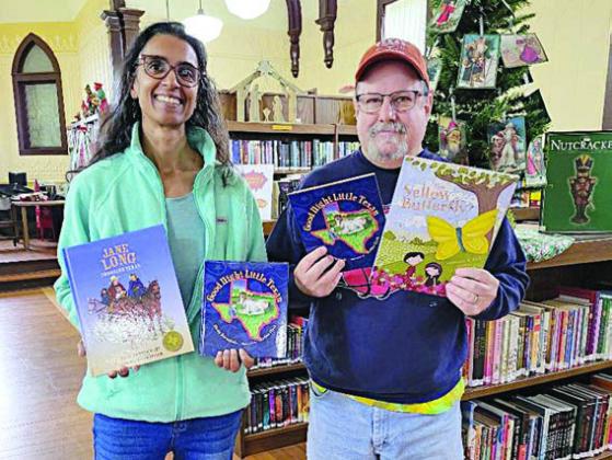 Round Top Family Library received books from Night Heron Media just before Christmas. Keelia Ritch (left), library manager, represents RTFL in accepting the donation from Mike Vance (right), Night Heron Media creative/video director.