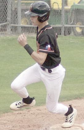 Eli Blansitt rounds third and heads home for a run against St. Paul. Sticker Photo By Darrell Vyvjala