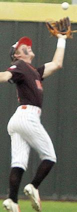 Left fielder Zane Brenek keeps two runs from scoring with a running catch late in game three. Sticker Photo By Darrell Vyvjala