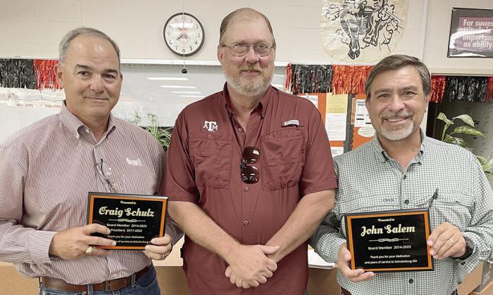 Outgoing trustees Craig Schulz (left) and John Salem (right) were recognized for each serving nine years on the SISD school board at Monday night’s meeting. Presenting them with plaques was Board of Trustees President Mike Zweschper (center). Sticker Photo By Darrell Vyvjala