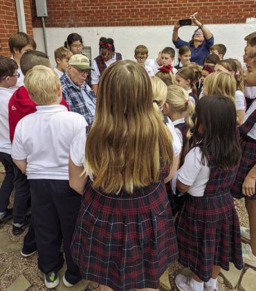 Bluebonnet Master Gardener Wallace Brown (center) instructs the students on planting their seeds and onion sets. In the background, Sheila Klimitchek, third grade teacher, is taking photos.