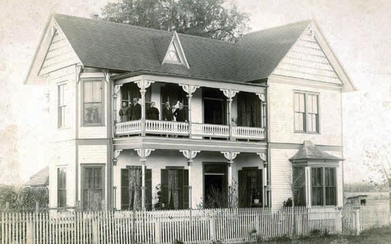 This 1890s photo graph pictures Augusta (Willenberg) and William Hermes,Jr., Louise (Holste) and Dr. William Hermes, and August Hermes on the upper balcony of William Hermes Jr.’s home, at 541 North Main St., La Grange.