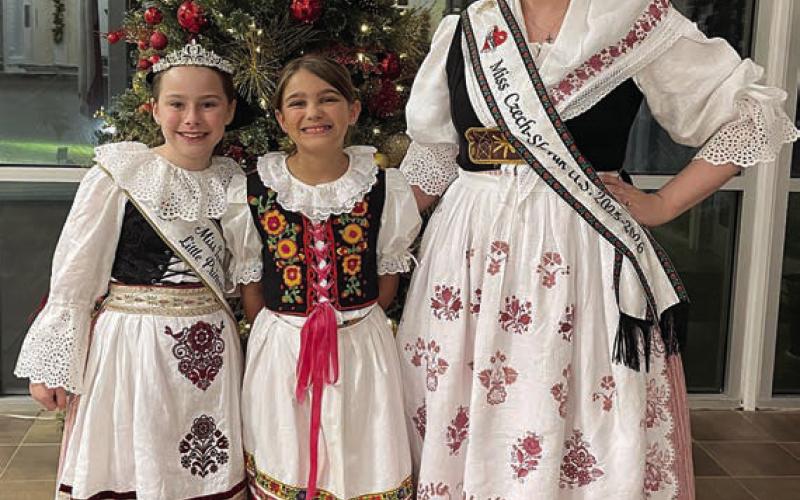 Wearing Czech krojs at the Fayette County Czech Heritage Society Christmas party were (from left) 2025-26 Miss Texas-Czech Slovak Little Princess Lillie Karstedt, Maelynn Wasut, and 2025-26 Miss U.S. Czech-Slovak Queen Madelyn Karstedt