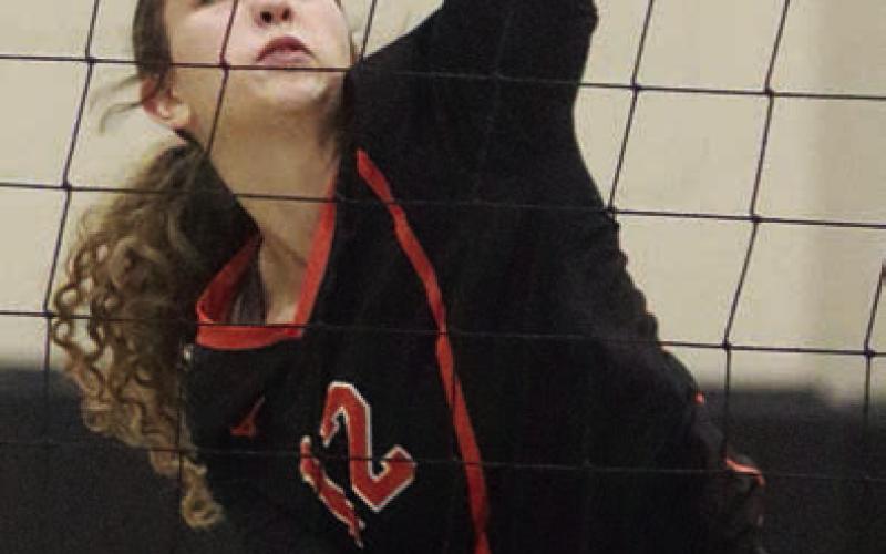 Grace Schramek connects for one of her two kills early in game three to help the Lady Horns jump ahead 11-0. Sticker Photo By Darrell Vyvjala