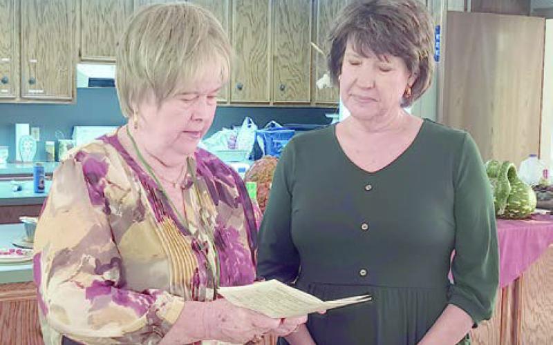 New member Diane Holub (right) was given the oath of membership by president Bonnie Baker (left).