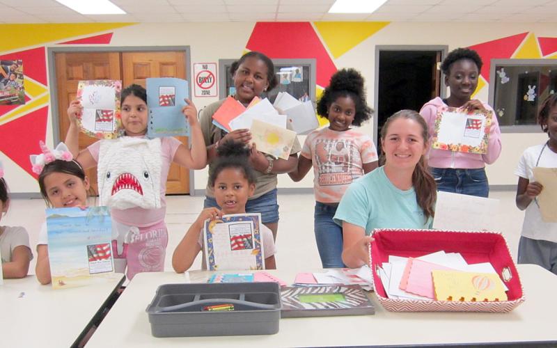 Lamun-Lusk-Sanchez Texas State Veterans Home in Big Spring – (front row, from left, sitting) Jocelyn Alejandres, Jaquelyn Alejandres, Reagan Bursey, Liberty Killion, (back, from left, standing) Monse De’Leon, Reginae Bursey, Fantasia Houston, Madison Harris and Makendra Harris display some of the 160 handmade cards.