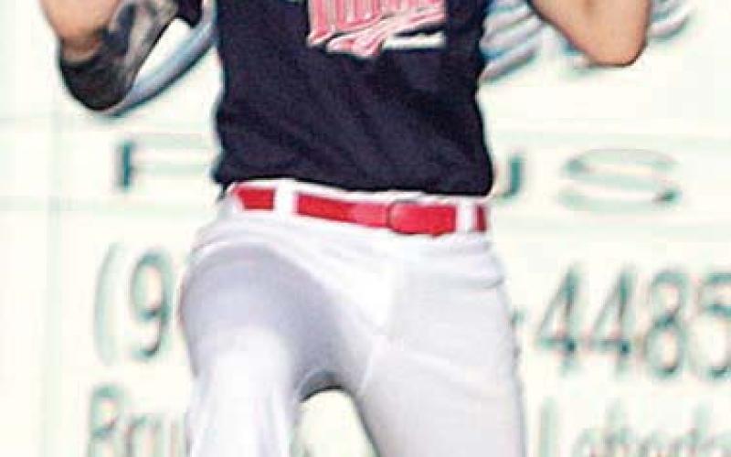 Left fielder Brayson Prihoda puts away a fly ball in the first inning. Sticker Photo By Darrell Vyvjala