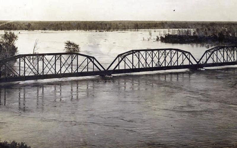 Photograph of the MKT railroad bridge across the Colorado River at La Grange on the evening of Dec. 5, 1913. Courtesy of Fayette Heritage Museum &amp;amp; Archives