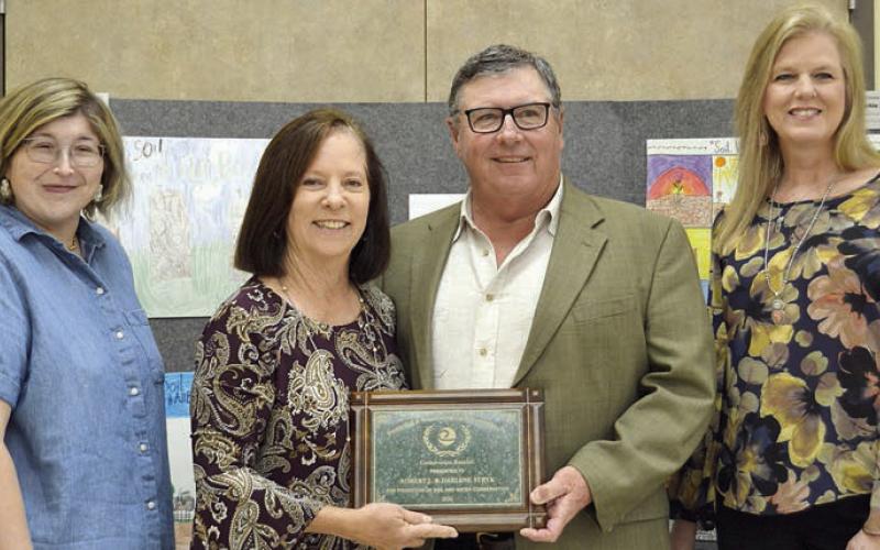 Darlene and Bob Stryk (center) accept the Fayette County Soil and Water Conservation District Conservation Rancher award. Making the presentation at last month’s banquet were Jessica Montez (left) of Fayette Electric Cooperative and Sherry Pfluger (right) of Round Top State Bank.