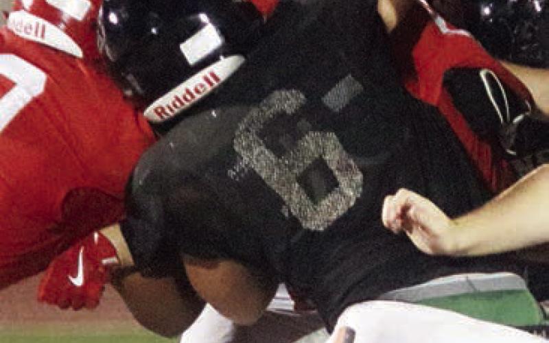 Ian Reeves (No. 6) and Jayvan Luhrs, two returners for 2025, team up to bring down a Cardinal runner. Sticker Photo By Darrell Vyvjala