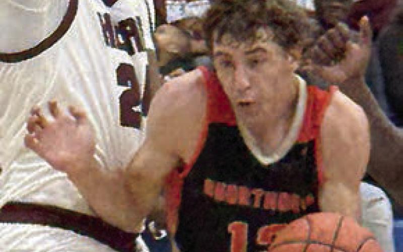 Van Prihoda slips by an Eagle on a second-quarter drive. Sticker Photo By Darrell Vyvjala