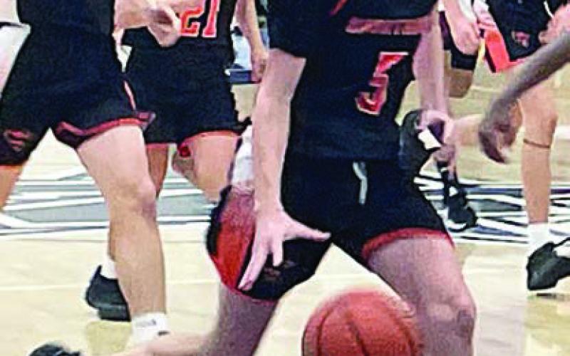 Jamison Bennett heads to the hoop on his way to drawing a foul in the fourth quarter. Sticker Photo By Darrell Vyvjala