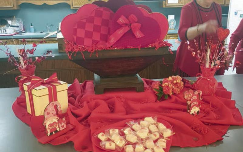 Both the centerpiece (left photo)) and the table centerpieces (right photo) reflected a Valentine’s theme.