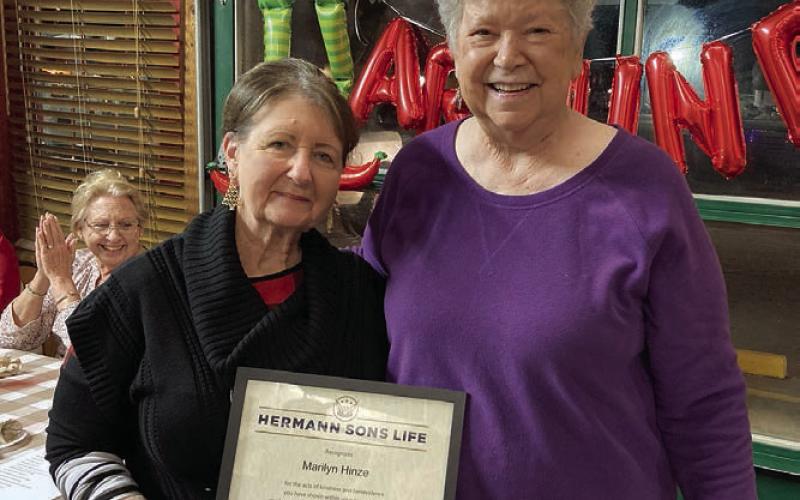 Marilyn Hinze (left) accepts the Humanitarian of the Year Award from Junette Rodecap, who serves as chair of the award committee for Hermann Sons Life.