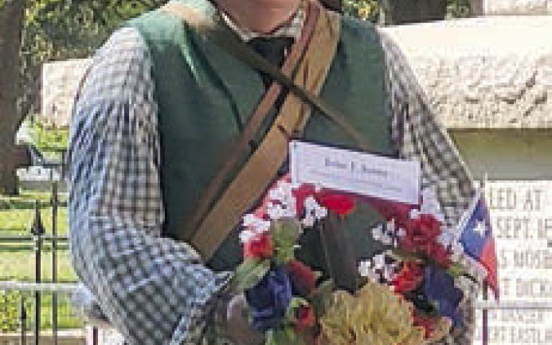 At a previous Texas Heroes Day at Kreische Brewery and Monument Hill State Historic Sites, a T exian reenactor carries wreath to lay at the tomb (photo above) and Texian reenactors line up to march to the bluff for the gun salute (photo at right).
