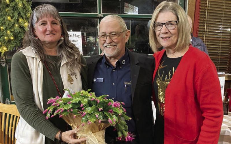A plant is being presented by Lodge 14 vice president Mary K. Seifert (right) to Hermann Sons Life Grand Lodge board member David Noak (center) for coming to present the pins. Also shown is Noak’s guest Theresa Garlin (left).