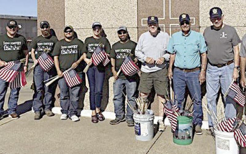 Helping place flags on th e graves of deceased veterans in area cemeteries ahead of Memorial Day were Invenergy staff members, who joined American Legion Post 143 for the annual project. Shown at St. Rose of Lima Catholic Cemetery with Post 143 members are five Invenergy staff from 7V Solar Ranch near Muldoon – (starting second from left) Matt Ray, solar tech; Cody Pruit, manager; Tori Serrato, solar tech; Karen Leighton, administrative assistant; and Art Rahman, solar tech.