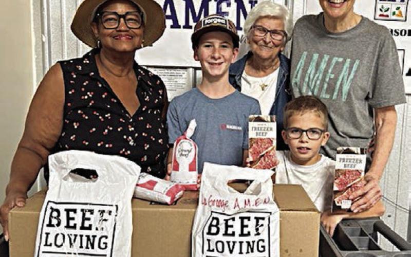Presentation to La Grange Area Ministry for Emergenc y Needs (AMEN) – Jacqueline Figg (left), NVCW pantry donation chair; Zoe Justiss (back, second from right), NVCW volunteer; and Susan Schultz (right), AMEN vice president.