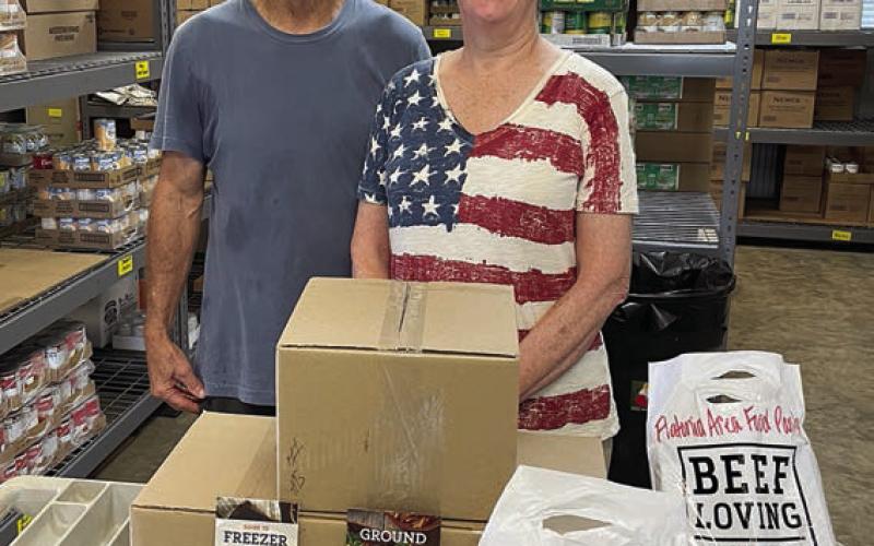Presentation to Flatonia Area Food Pantry – (from left) Larry Haas, president of Flatonia Area Food Pantry, and Jackie Harker, NVCW secretary.