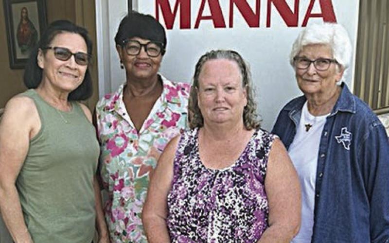 Presentation to Mann a/LAMB in Hallettsville – Ordet Klekar (second from right), Manna/LAMB volunteer; Jacqueline Figg (second from left), NVCW pantry donation chair; Zoe Justiss (right), NVCW volunteer; and another Manna/LAMB volunteer at left.