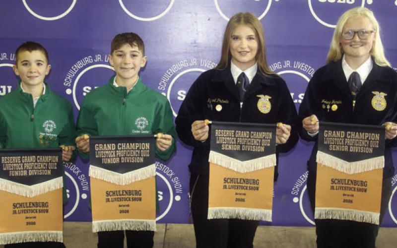 PROFICIENCY QUIZ – From left: Gage Smrkovsky, Junior Division reserve champion; Crockett Guenther, Junior Division grand champion; Kyrroll Prihoda, Senior Division reserve champion; and Jolene Jarvis, Senior Division grand champion. Winners scored the best on a test over general livestock knowledge. Sticker Photo By Darrell Vyvjala