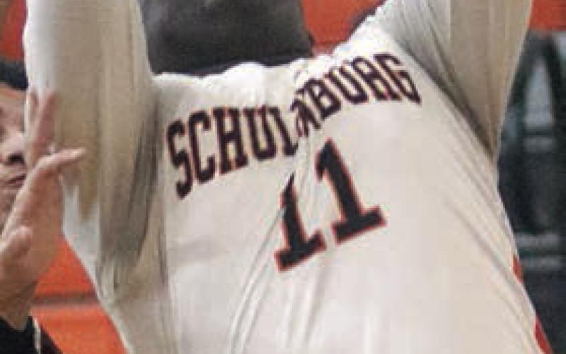 Tavondrick Ellison scores under the basket in the first quarter against Ganado. Sticker Photo By Darrell Vyvjala