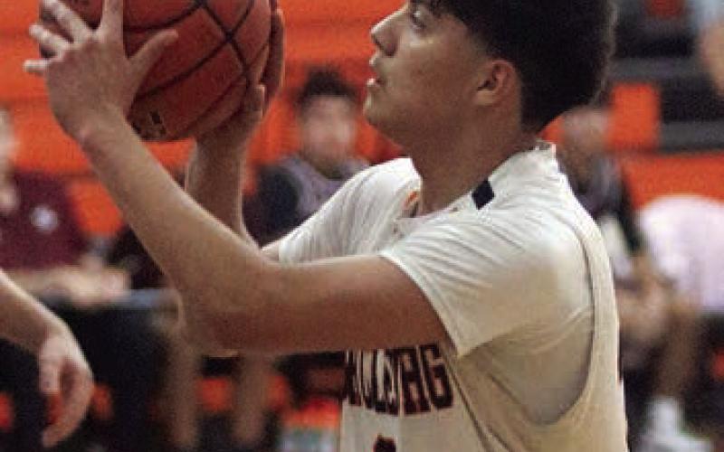 Victor Mandujano sets himself before releasing one of his two three-point field goals on Jan. 6. Sticker Photo By Darrell Vyvjala