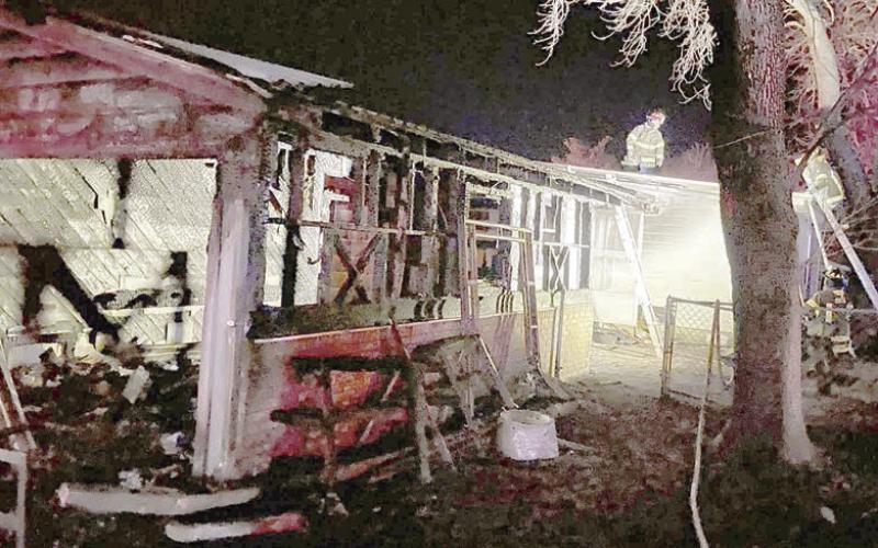 Firefighters continue to work in the early morning hours of Jan. 21 after a fire gutted the garage at the intersection of Bohlmann Avenue and Baumgarten Street. Photo Courtesy of SVFD