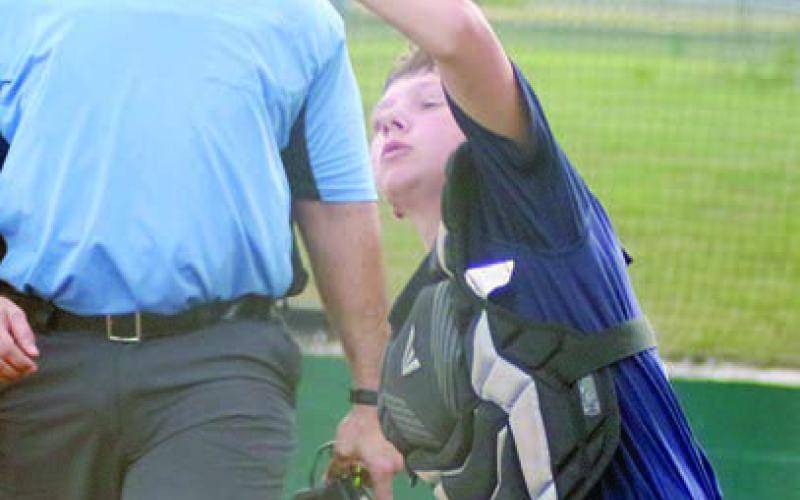 Catcher Holden Holub secures a popup in foul territory in the bottom of the second inning last Wednesday. Sticker Photo By Darrell Vyvjala