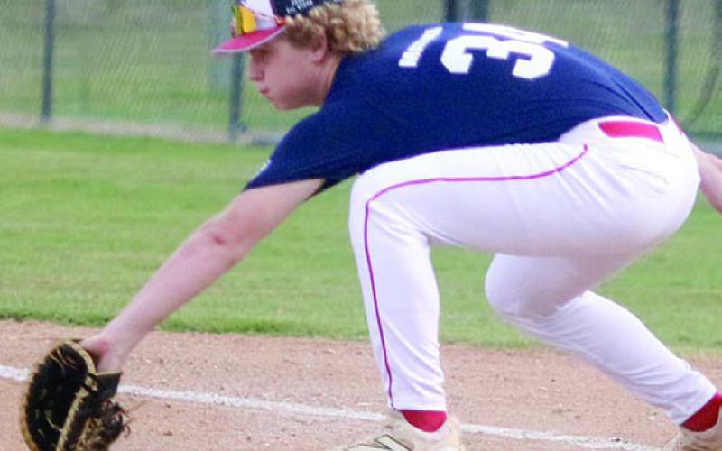 Colton Matura scoops a throw in the dirt at first base during game two. Sticker Photo By Darrell Vyvjala