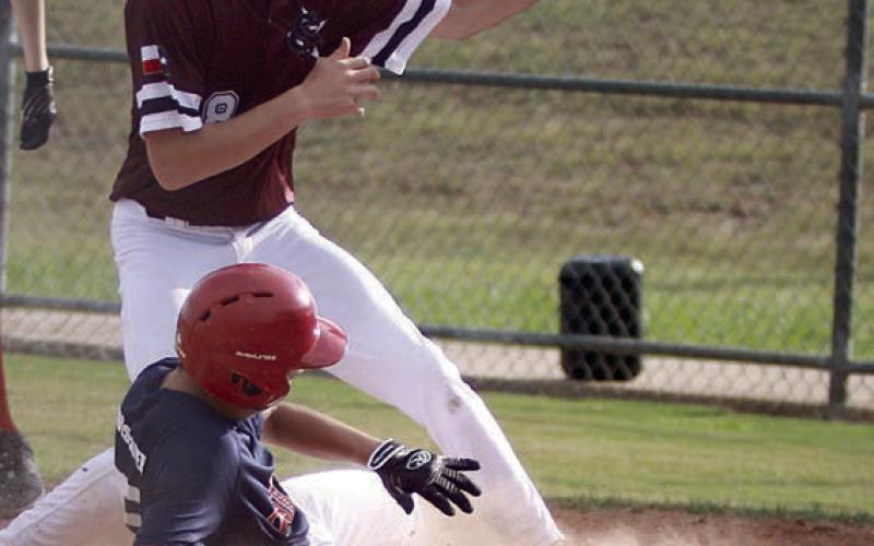 Dylan Zweschper slides home to score a run on a wild pitch in the top of the first inning last Tuesday. Sticker Photo By Darrell Vyvjala
