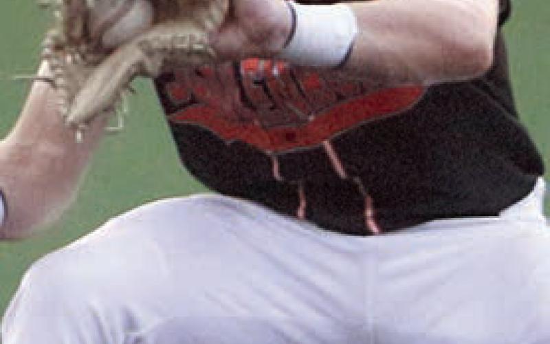 Shortstop Reid Janda fields a grounder to start a double play in the third. Sticker Photo By Darrell Vyvjala
