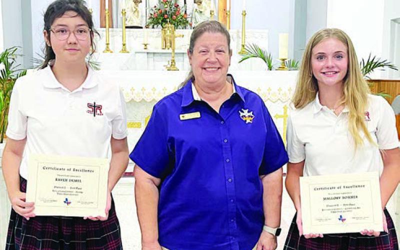 St. Rose of Lima students presented certificates at the end of the school year as first-place winners in the state Catholic Daughters of America Education Contest were Raven Demel (left), Division 1 Poetry, and Mallory Bonner (right), Division 2 Computer Art. Also shown is CDA Regent Grace Lebeda (center).