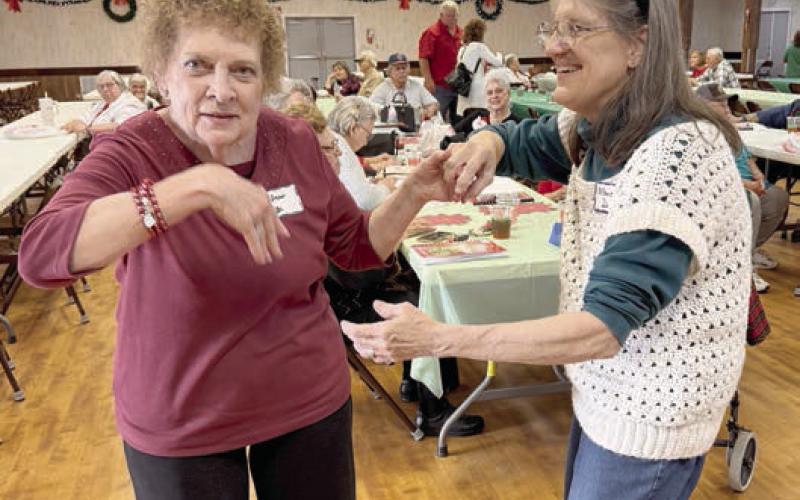 Dancing to the music of Super Dave Hollas are (from left) Janis Kutac and Monica Dunsworth.
