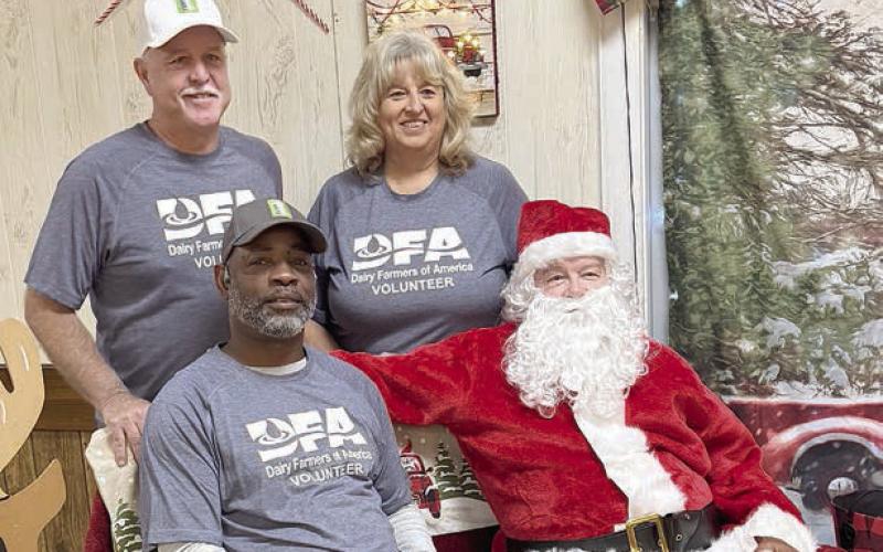 Volunteers from Dairy Farmers of America shown with Santa are (front) Leon Brooks, (back, from left) Johnny Osborn and Jackie Vornsand.