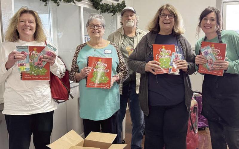 Weimar Encore Lions Club donated these fun activity books for Senior Connections members. The books came with coloring tools too! Shown are (from left) Nancy Parrish, Linda Heller, Tommy and Denise Koenig, along with Senior Connections executive director and head chef Amanda Kridel.