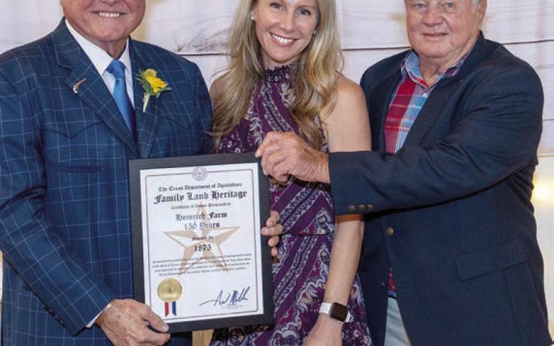 Texas Agriculture Commissioner Sid Miller (left) presents the Family Land Heritage Certificate to Bob Heinrich (right) and his daughter, Stacey Heinrich Smatresk. Also on hand for the award were Bob’s grandchildren Ryker, Barrett, and Sidney Smatresk as well as his son-in-law Erik Smatresk.