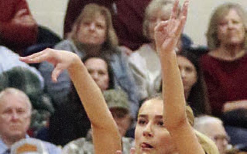 Jenna Guentert hits a three-pointer for the Lady Horns’ first basket. Sticker Photo By Darrell Vyvjala
