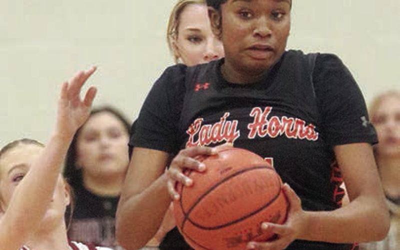 Jashiya Jackson comes down with a steal of an Iola pass in the final period. Sticker Photo By Darrell Vyvjala