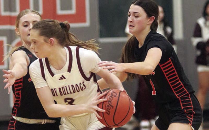 Ava Faith (right) and Mallory Bonner pressure a Lady Bulldog in the fourth quarter.